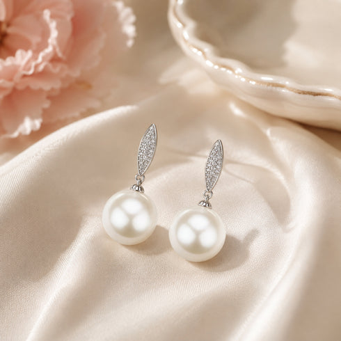 Earrings pair with 11–12mm freshwater pearl drops and marquise zirconia accents