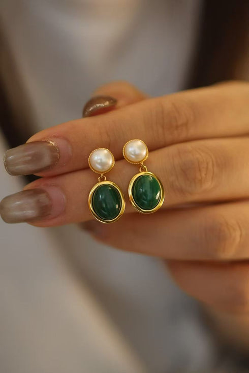 Earrings: pair of oval malachite drop earrings with gold-tone bezels and pearl stud tops.
