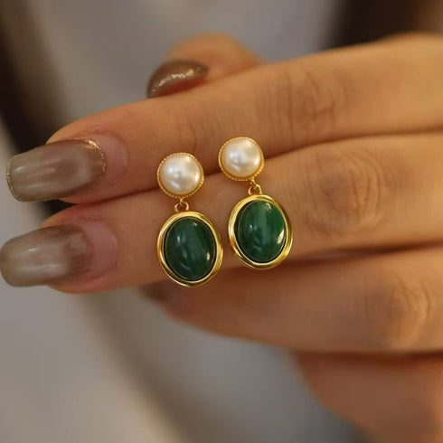Earrings: pair of oval malachite drop earrings with gold-tone bezels and pearl stud tops.