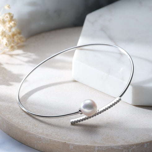 Bracelet: silver bangle with a single Akoya pearl and a pavé CZ curved bar