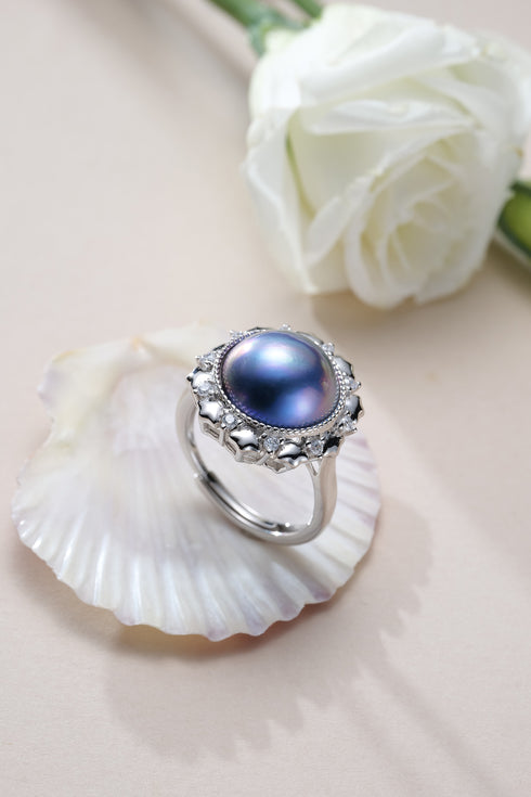 Ring with blue mother-of-pearl cabochon in an ornate silver setting by House of Pearls