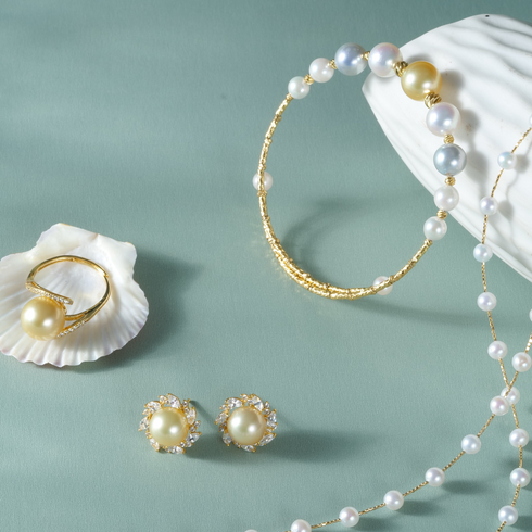 Pearl bangle bracelet with golden South Sea and Akoya pearls on a textured gold band