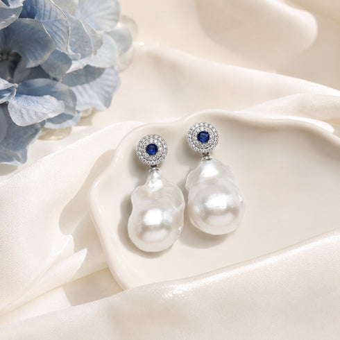 Sapphire White freshwater baroque pearl earrings by House Of Pearls with blue sapphire center and pave diamonds
