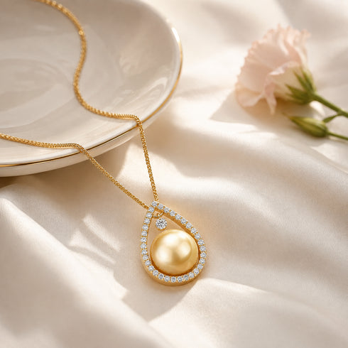 Necklace: gold South Sea pearl teardrop pendant with diamond halo on a gold chain