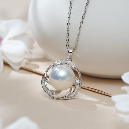 Necklace pendant featuring a 12–13mm Edison pearl in a silver spiral halo with baguette-cut stones