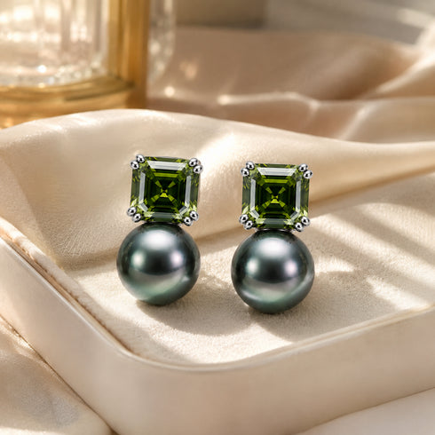 Earrings pair: olive-green square-cut stones above 10–11mm Tahitian baroque black pearls in silver settings