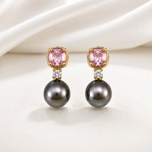 Pair of earrings with pink cushion-cut stones in gold settings, small diamonds, and dark Tahitian pearls.