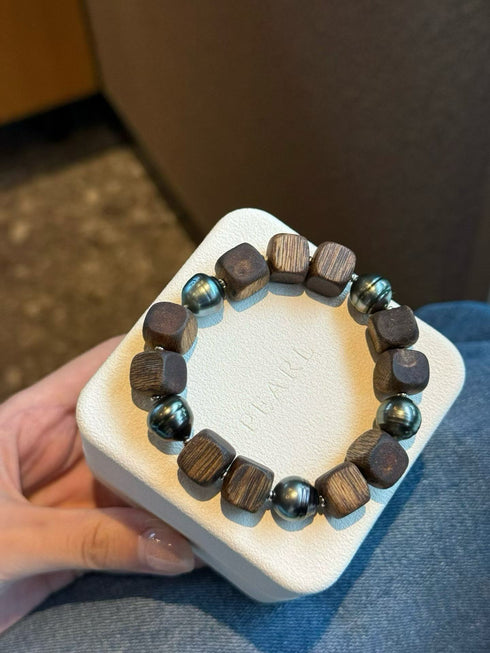 Bracelet: Agarwood and Golden South Sea pearl stretch bracelet with dark wood cube beads and teal pearls