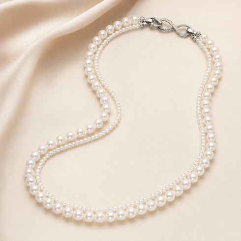 Versa Infinity Dual-Strand Freshwater Pearl Necklace with two pearl strands and infinity clasp on satin background