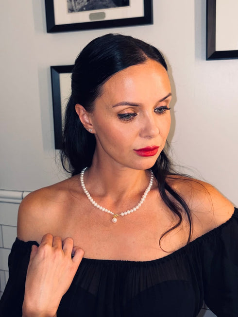 White freshwater pearl pendant collar necklace on model with subtle gold accent