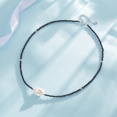 Necklace: Black spinel beaded choker with baroque pearl pendant and silver heart-extender.