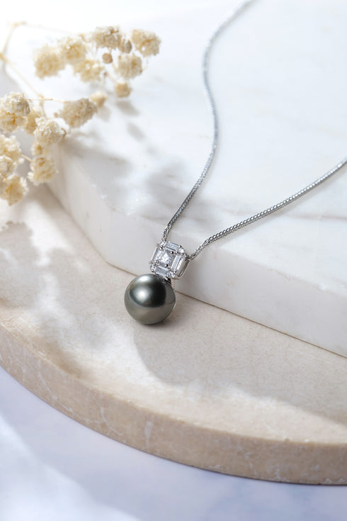 11-12mm Tahitian black pearl Midnight Glow pendant on a silver chain with a square-cut gemstone accent