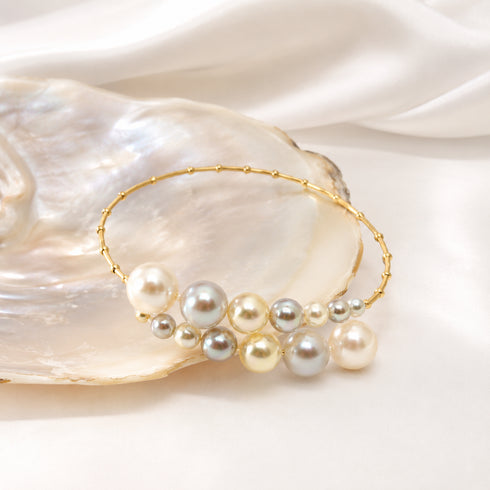 Bracelet: Celestial Tide Japanese Akoya Pearl Bangle in 18K gold with mixed-size pearls