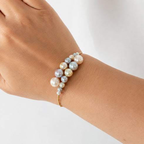 Celestial Tide Japanese Akoya Pearl Bangle Bracelet in 18K gold with pastel multicolor pearls.