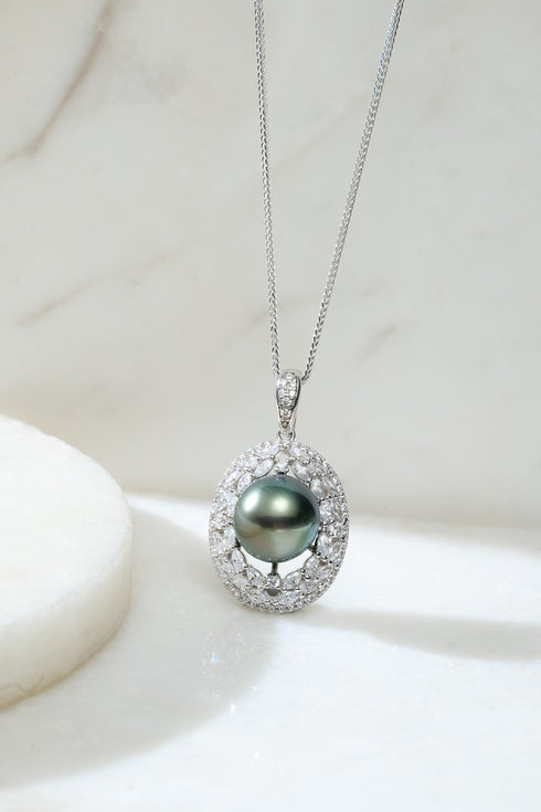 Tahitian black pearl pendant necklace with diamond halo on silver chain.