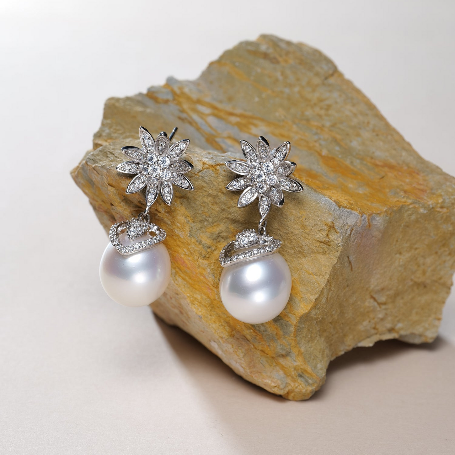 Pair of House Of Pearls Ocean Aster earrings featuring 11-12mm white South Sea oval pearls with crystal flower accents