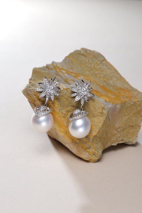 Earrings with crystal-studded flower tops and 9–11mm white baroque pearl drops