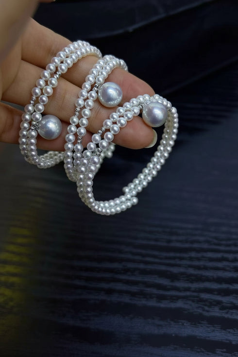 Aurora freshwater pearl double chain bracelets, white pearl strands with large accent pearls, stacked on fingers