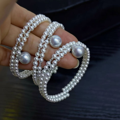 Aurora freshwater pearl double chain bracelets, white pearl strands with large accent pearls, stacked on fingers