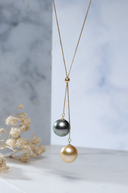Tahitian black pearl pendant necklace on a gold-tone chain with green-blue and gold pearl drops