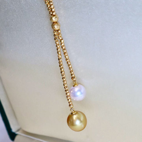 Necklace: Akoya & Golden South Sea Pearl Y-necklace in 18K gold with white Akoya and golden South Sea pearls.