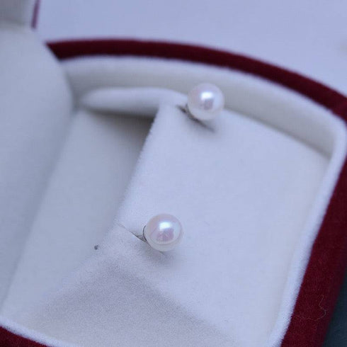 Earrings: pair of 6-7mm white Akoya pearl stud earrings in silver settings