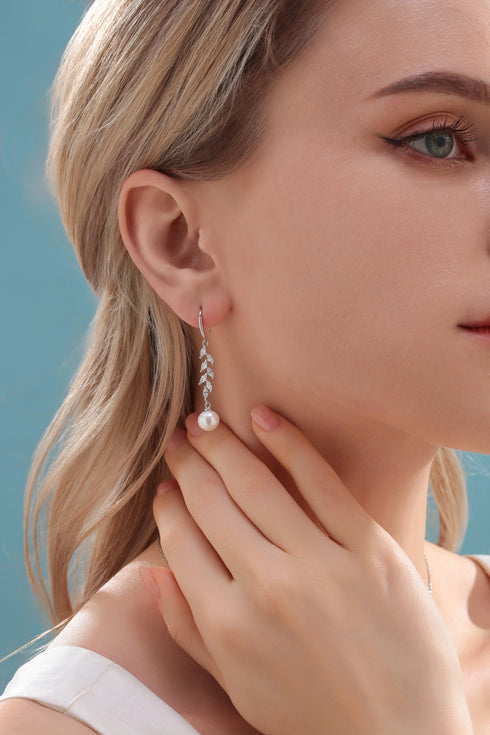 Earrings with 8-9mm freshwater pearl drop and long-leaf cubic zirconia accents on a silver-tone chain.