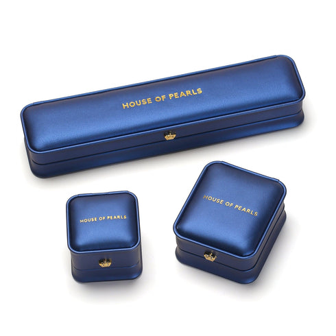 Earrings boxes by House Of Pearls: four blue cases with gold logo.