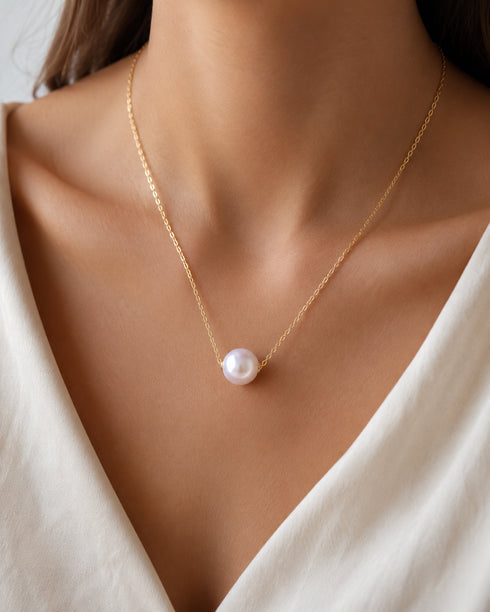 Freshwater pearl floating necklace with a 12-13mm pearl on a delicate gold chain