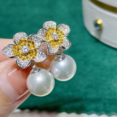 Flower freshwater pearl jewelry set with diamond-accent blooms and yellow centers paired with a pearl strand