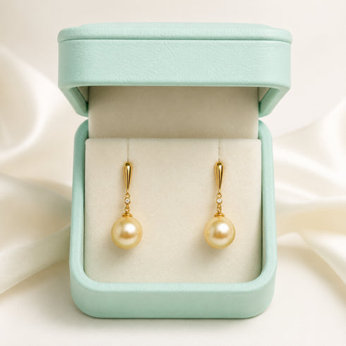 Pair of 10–11mm Golden South Sea Pearl minimalist drop earrings with gold-tone settings and small diamonds