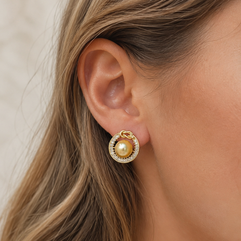 Halo stud earrings featuring a 10mm Golden South Sea Pearl surrounded by a pave crystal halo in gold vermeil