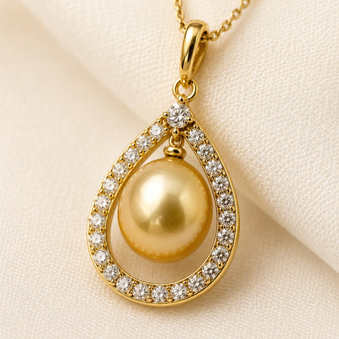 Gold teardrop pendant necklace featuring a 10-11mm Golden South Sea pearl and CZ stones