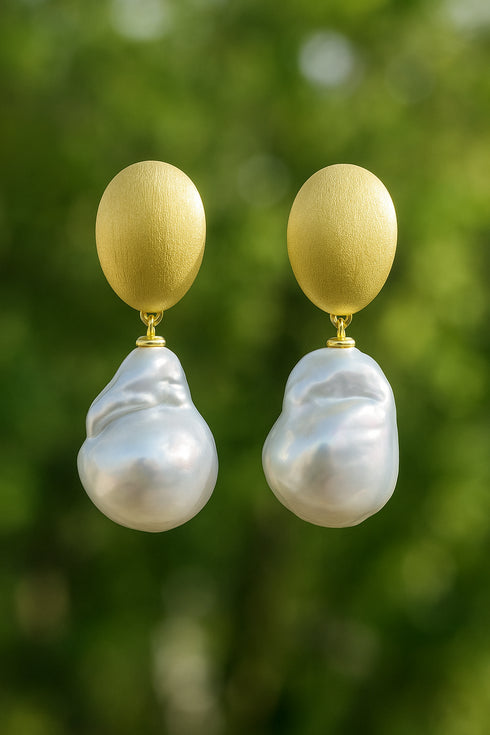 Earrings: pair of 13–14mm white South Sea baroque pearl drops with brushed gold oval tops.