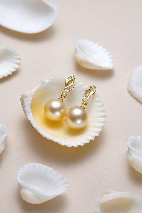 Earrings pair by House Of Pearls XM: 10-11mm golden South Sea pearl drops with floral gold setting.