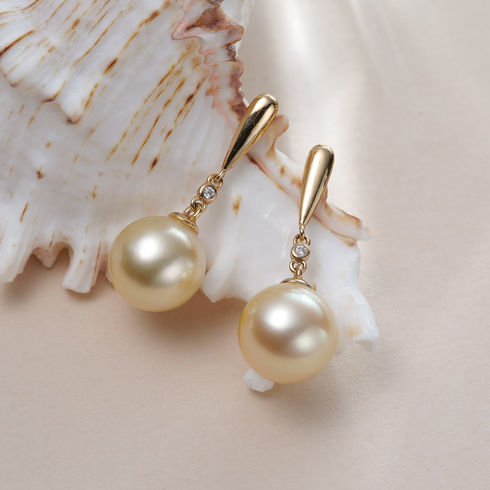 Pair of gold drop earrings with 10–11mm Golden South Sea pearls and diamond accents by House Of Pearls XM.