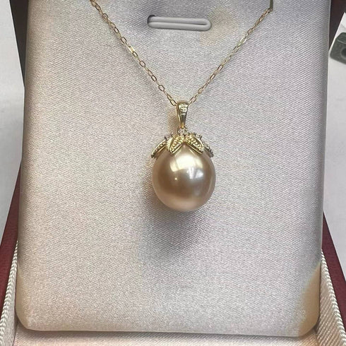 Pendant necklace with a 12–13mm Golden South Sea pearl on a gold chain, diamond-accented cap by House Of Pearls TA