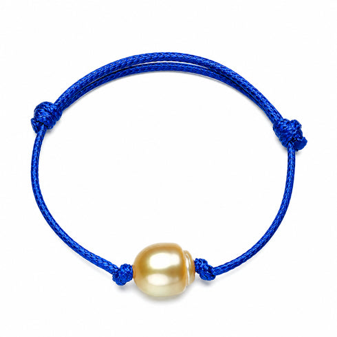 Bracelet with blue knotted adjustable cord and a golden South Sea baroque pearl centerpiece