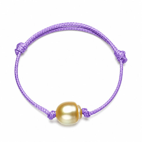 Bracelet with purple knotted adjustable cord and golden South Sea baroque pearl centerpiece