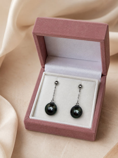 Tahitian pearl drop earrings in sterling silver with dark iridescent pearls on delicate chains in a pink velvet box