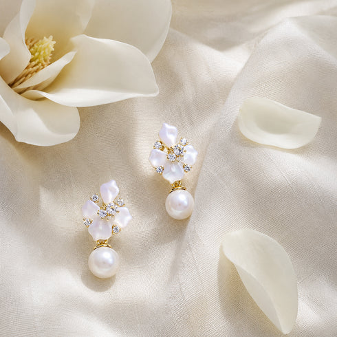 Pair of earrings with floral mother-of-pearl petals, crystal accents, and pearl drop in a gold-tone setting