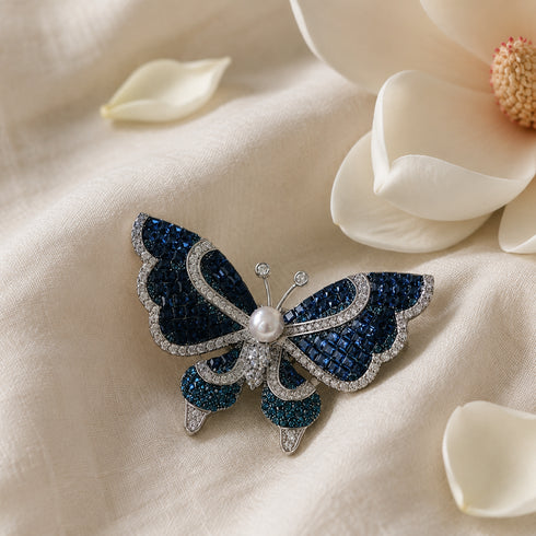 Butterfly brooch by House Of Pearls featuring blue crystal wings and freshwater pearl center