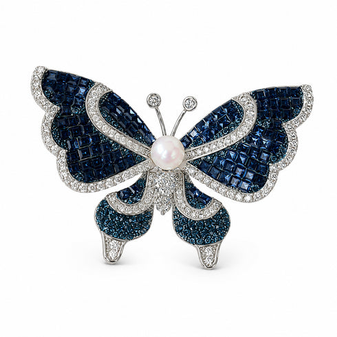 Butterfly brooch with deep blue crystal wings and a 5–6mm freshwater pearl centerpiece on silver-tone metal