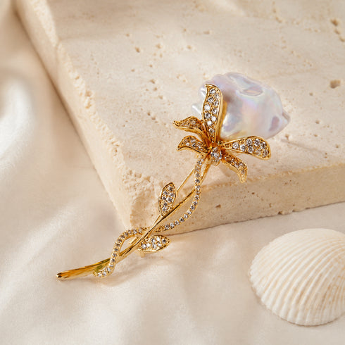 Rose Baroque Pearl Brooch, gold-tone floral pin with crystal-studded petals and baroque pearl.