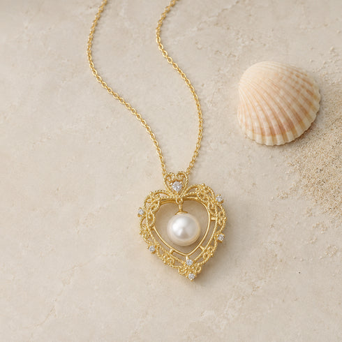 Vintage hollow-heart freshwater pearl pendant necklace in gold-tone with crystal accents