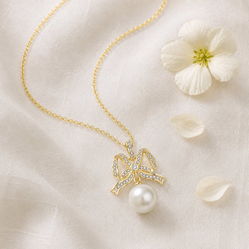 Pendant necklace: gold-tone bowknot with CZ stones and freshwater pearl drop, House of Pearls-TA