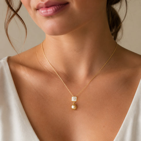 Necklace with a square mother-of-pearl pendant and a golden South Sea pearl drop on a delicate gold chain