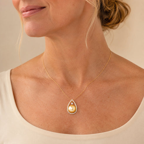Necklace with a 10-11mm Golden South Sea pearl teardrop pendant on a thin gold chain.
