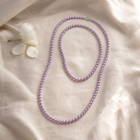 35-inch purple freshwater pearl rope necklace, AAA grade, on beige fabric with white flower petal accents