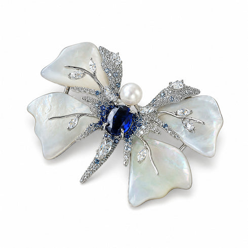 Butterfly brooch by House Of Pearls; pearl-white shell wings with blue center stone and pave crystals